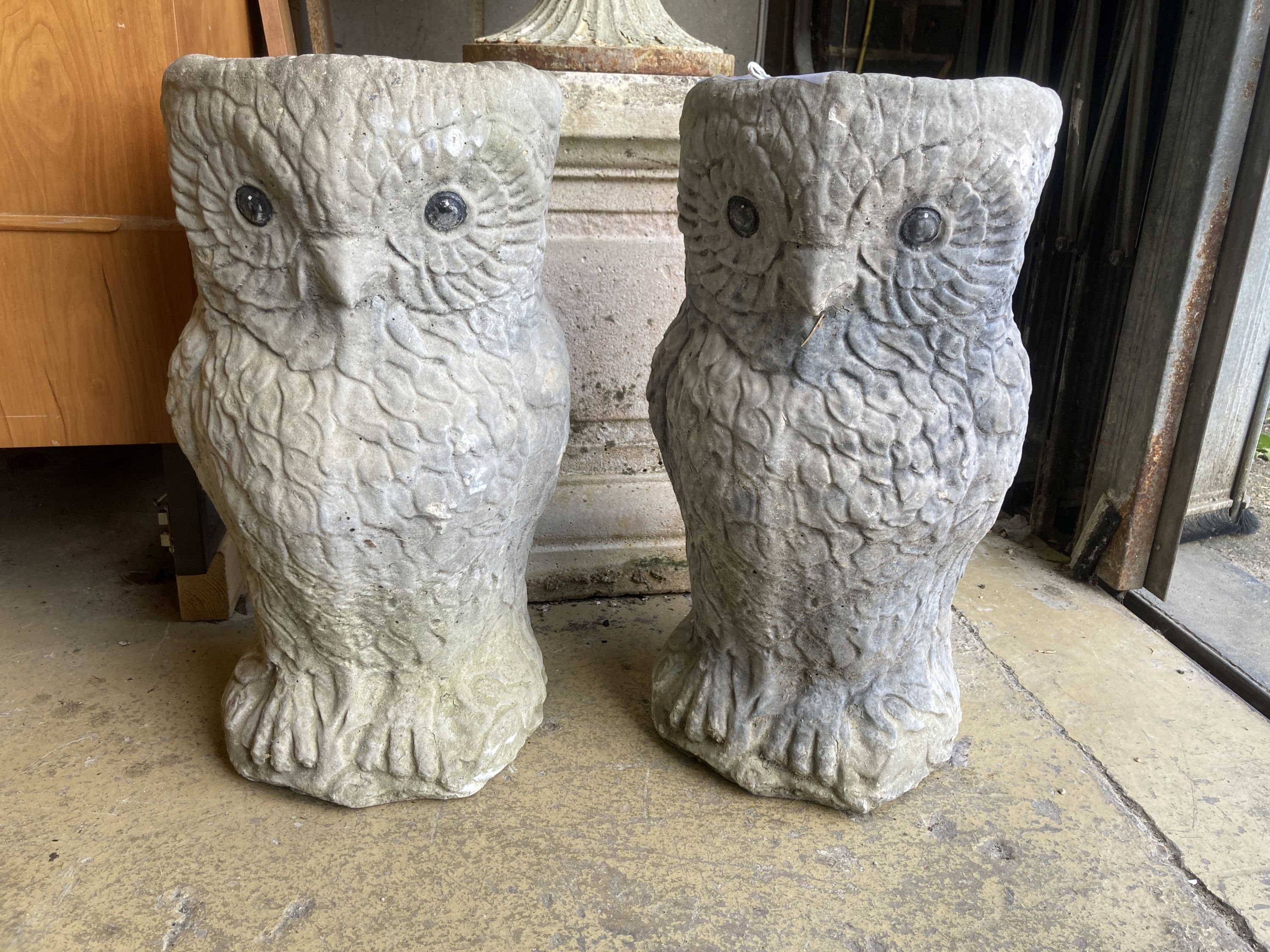 A pair of reconstituted stone owl garden planters, height 50cm